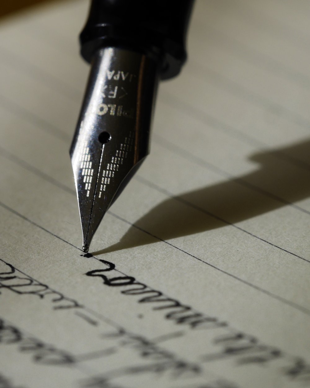 A fountain pen writing on paper, illustrating a clear written plan