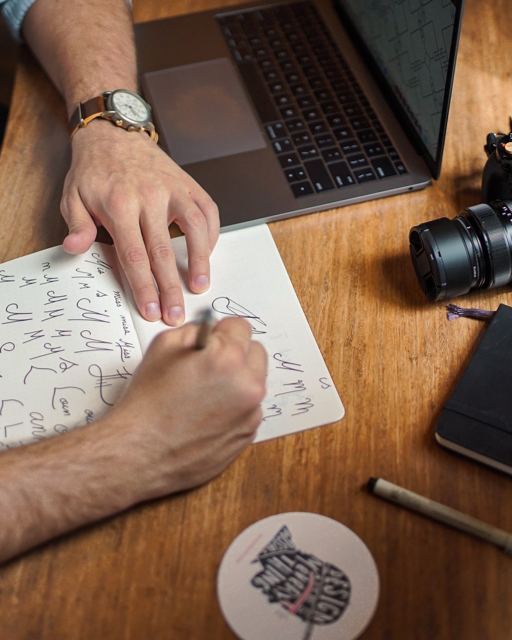 Hands sketching a plan on paper next to a laptop, mapping where AI fits