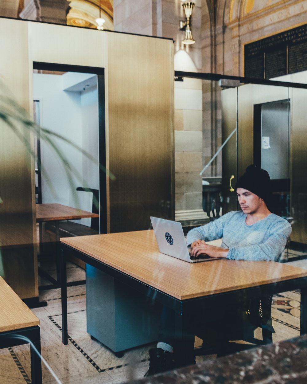 A person working on a laptop in a modern open office
