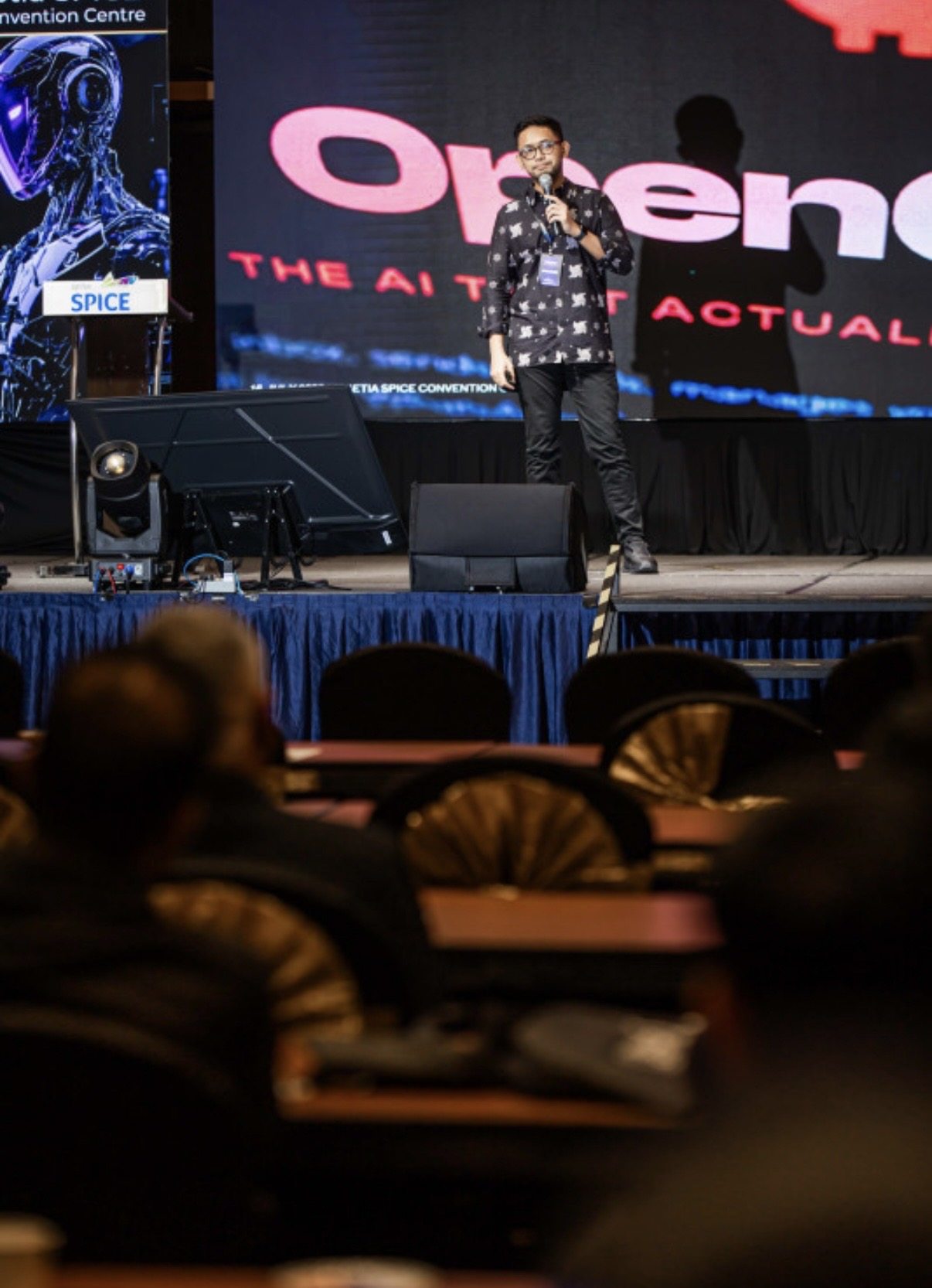 Wide view of the PDX2026 stage during Abi Mangku's talk, audience in the foreground and the OpenClaw slide on screen